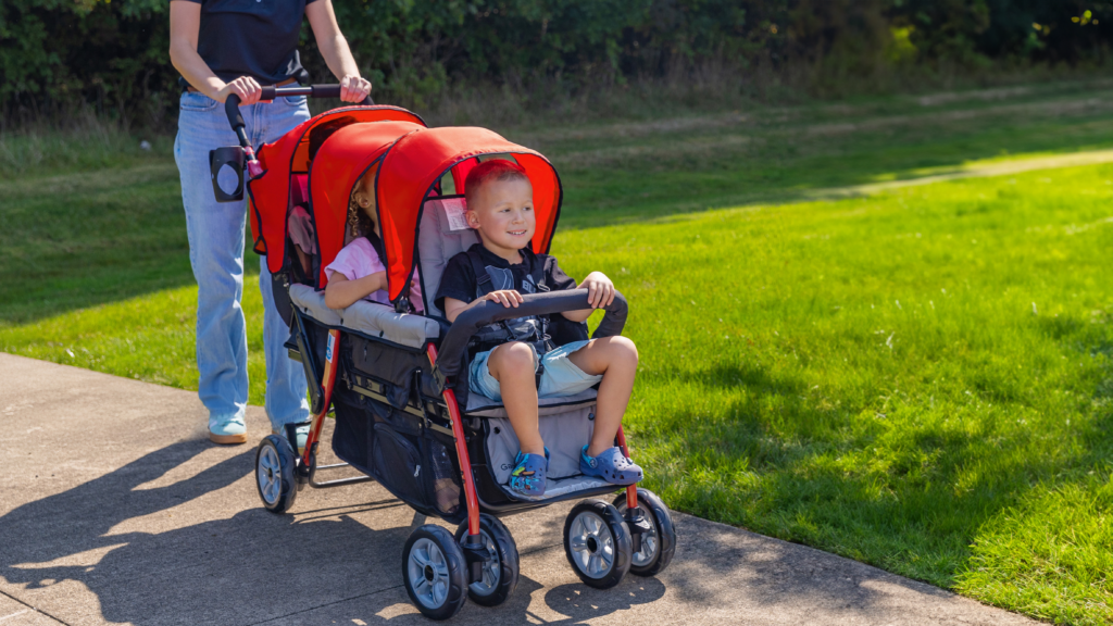 Three children being pushed in a triple stroller
