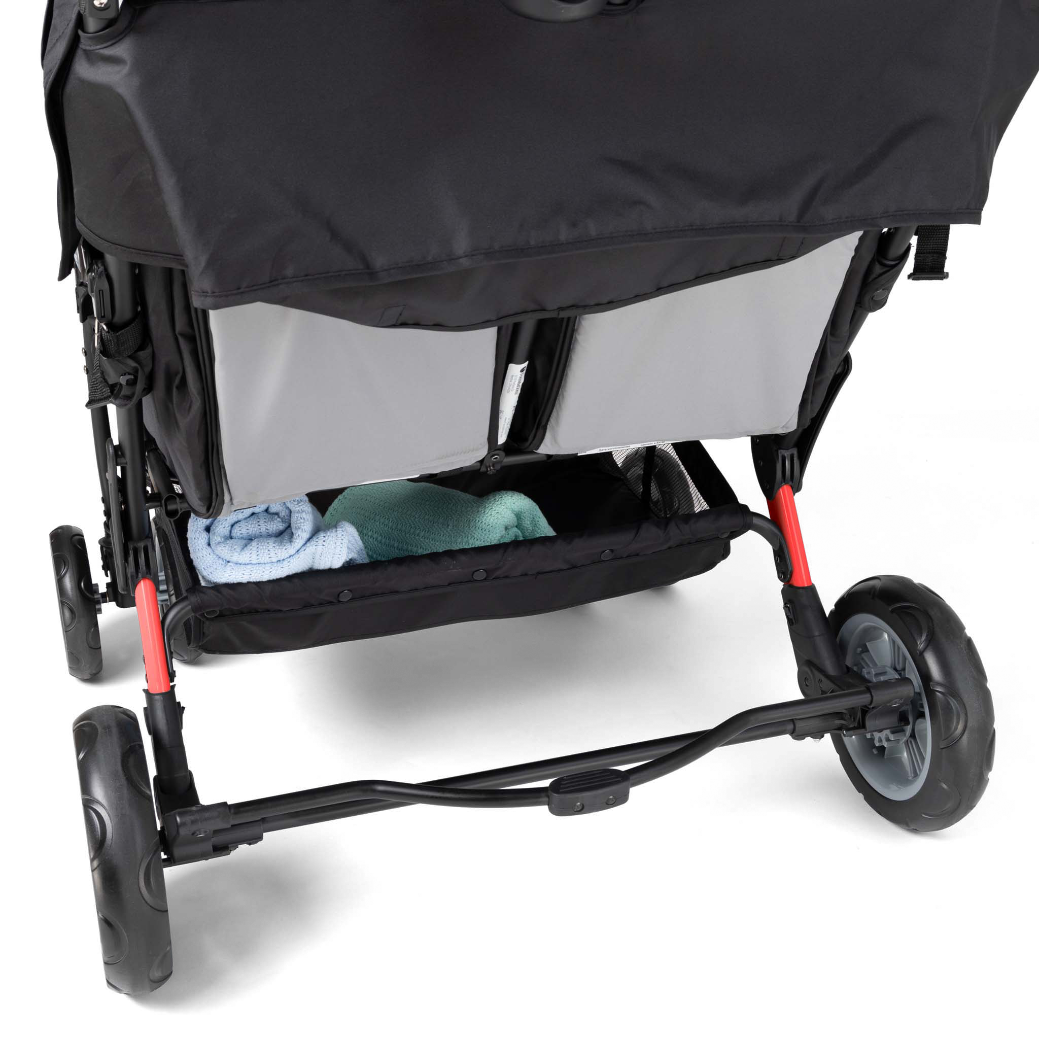 quad stroller with a storage basket containing blue and green items 