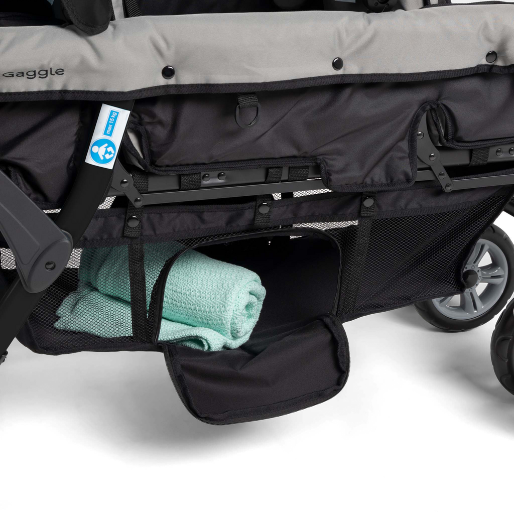 Close-up of a stroller with a green towel inside storage
