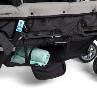 Close-up of a stroller with a green towel inside storage