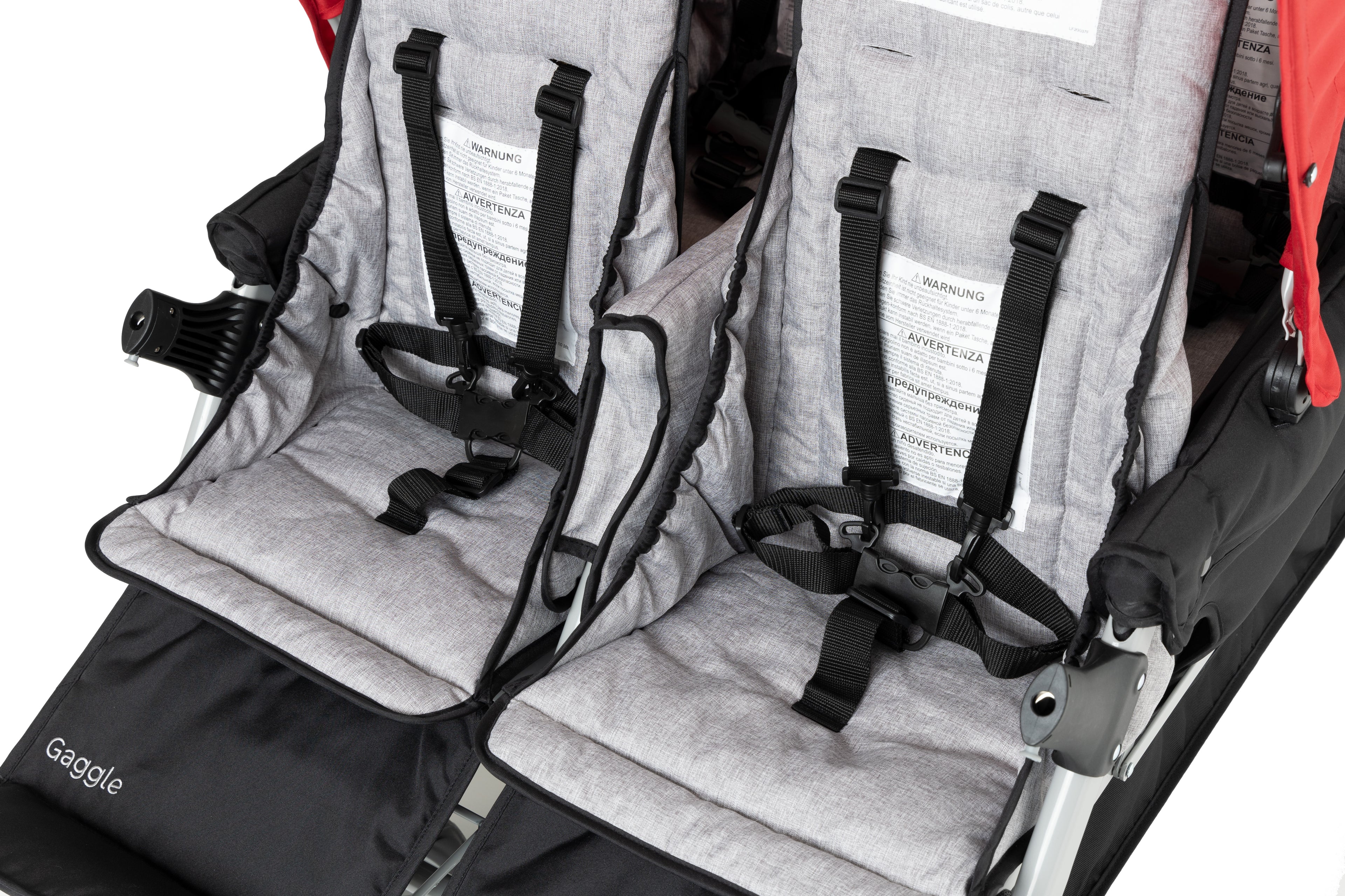 Two gray baby seats with black harness