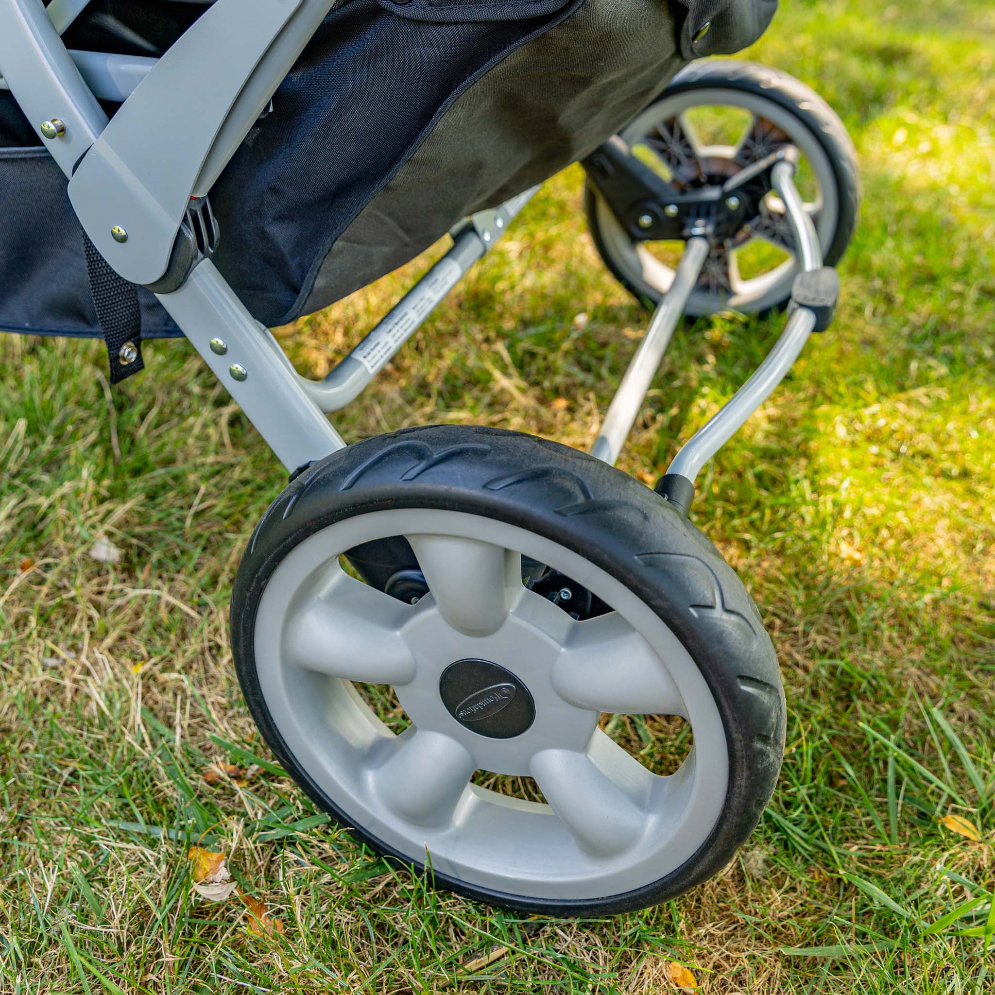 Close-up of a stroller wheel on grass