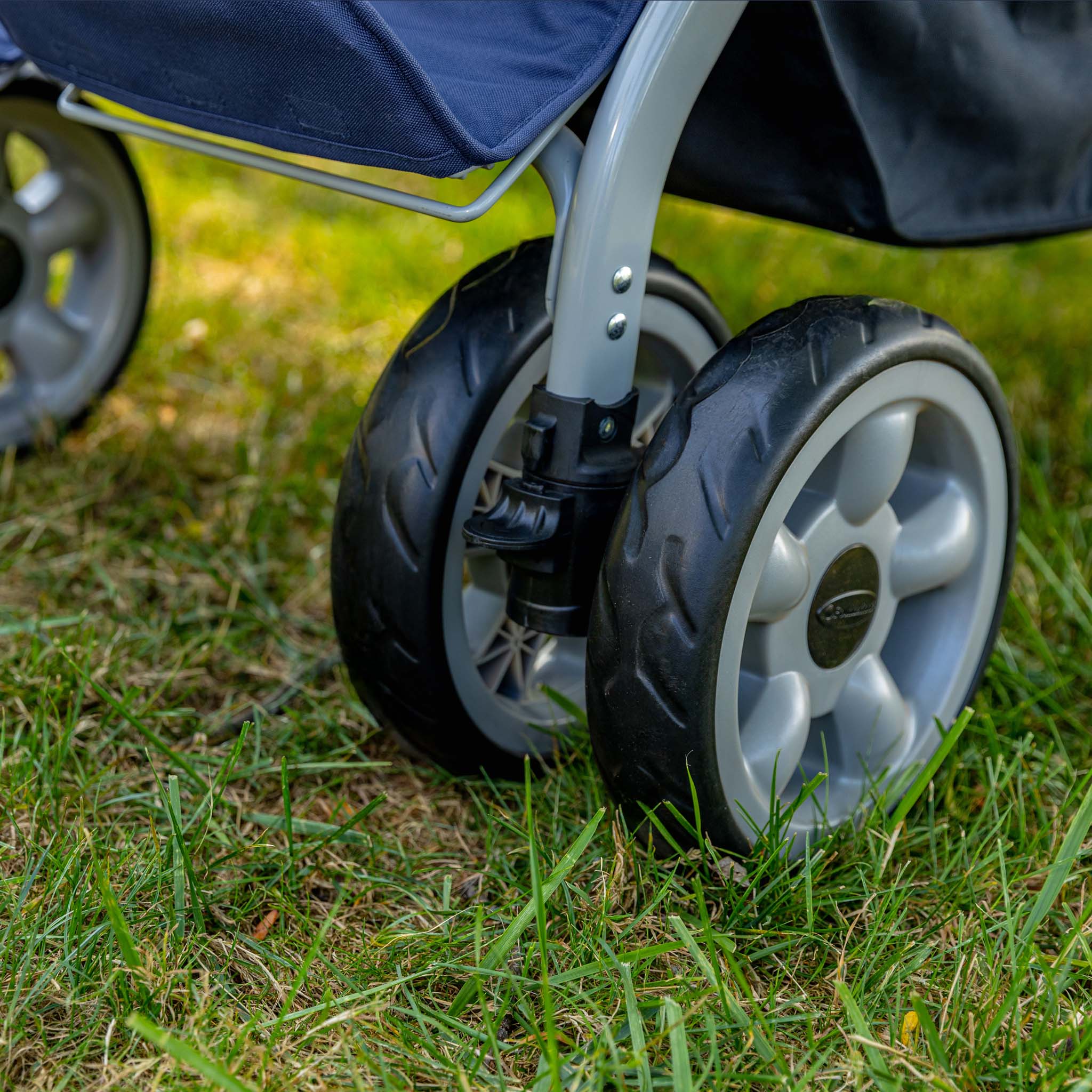 Close-up of a stroller wheel on grass
