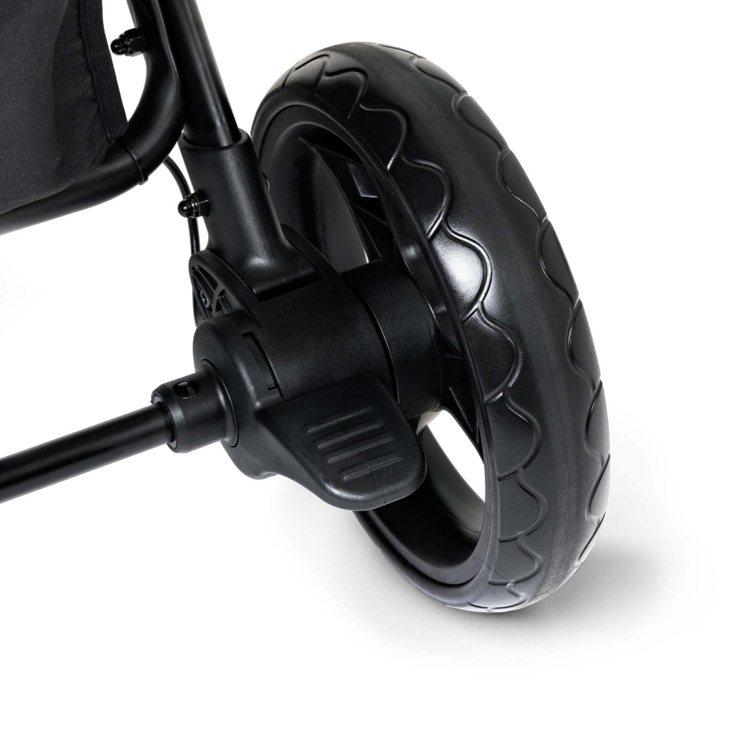 Close-up of a black stroller wheel and foot brake