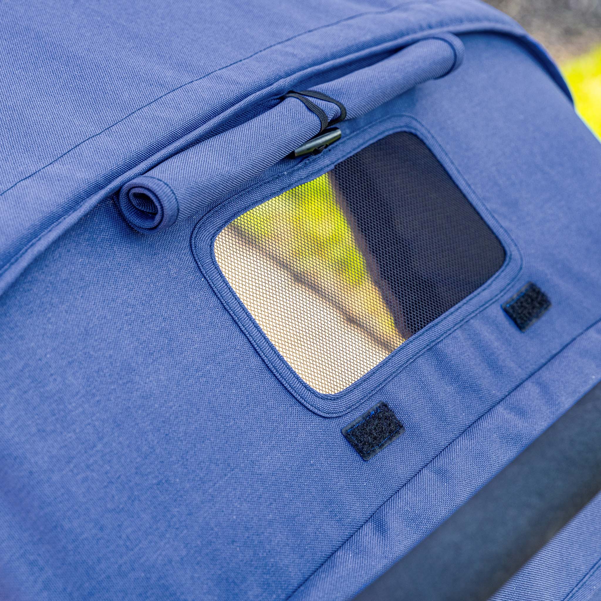 Close-up of a blue 4 seat stroller with a window, showing texture and design details.