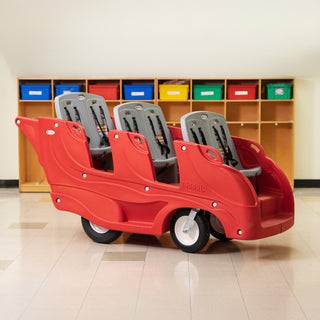 Red plastic buggy with six gray seats in a room with colorful lockers.