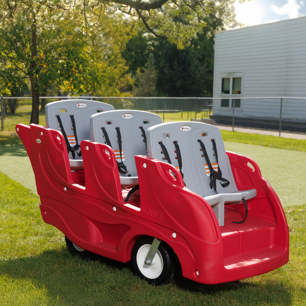 Red plastic6 seat buggy with gray seats on a grassy area